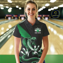Load image into Gallery viewer, Female model in a bowling alley wearing a black bowling polo with green cobra artwork and bowling-themed accents.