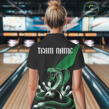 Load image into Gallery viewer, Back view of a black womens bowling polo showcasing a green cobra, bowling ball, and scattered pin graphics.