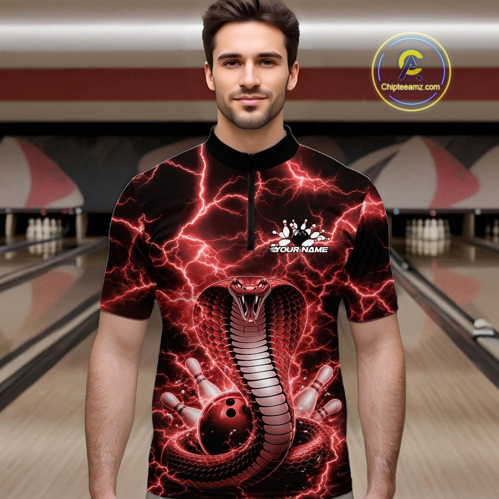 Male model in a bowling lane wearing a quarter-zip with red cobra artwork and a lightning background.