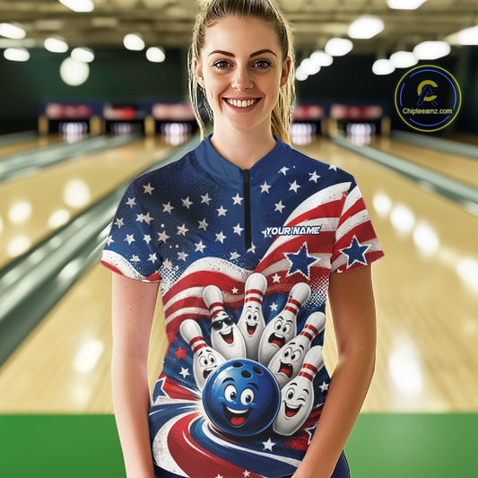 Front view of a female model wearing a bowling quarter zip shirt showcasing a funny bowling ball with cheerful animated pins, flowing American flag waves, and scattered stars in a bowling lane.
