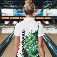 Load image into Gallery viewer, Back view female model in bowling lane wearing polo shirt with flaming bowling ball crashing into pins green fiery bowling artwork