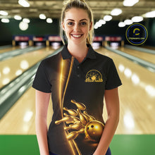 Load image into Gallery viewer, Front view of a female model in a bowling lane wearing a black polo shirt with golden bowling ball and pins artwork and refined bowling visuals.