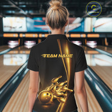 Load image into Gallery viewer, Back view of a female model in a bowling lane wearing a black polo shirt featuring a golden bowling ball and pins design with elegant athletic bowling graphics and clean sporty styling.