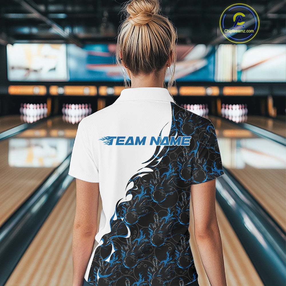 Back view of a female model in a bowling lane wearing a white quarter-zip shirt featuring blue and black flame bowling pattern with sporty athletic graphics.