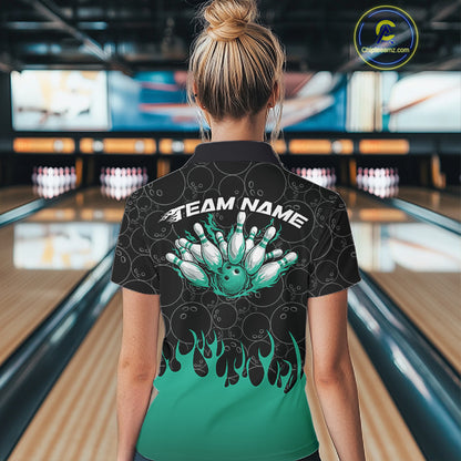 Inside a bowling lane, back view of a female model wearing a black bowling quarter-zip shirt with vibrant turquoise flames, featuring flaming bowling ball action artwork.