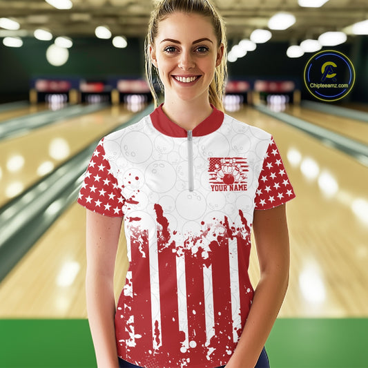 Female bowlers wearing matching custom red American flag quarter-zip team shirts on the bowling lane.