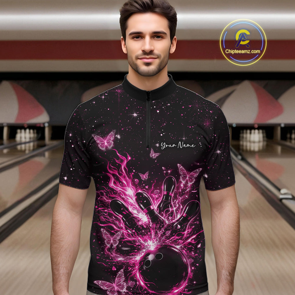 Male model wearing a black and pink bowling quarter-zip shirt at the lane with cosmic flaming strike artwork.