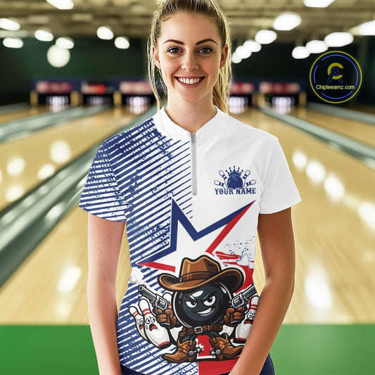 A woman standing in a bowling alley wearing a custom-designed short-sleeve bowling shirt. The shirt features a white and blue striped pattern on one side, a blue star graphic, and a cartoon bowling ball character dressed as a cowboy on the front.