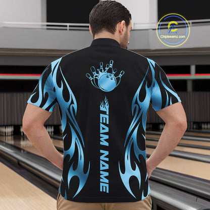 At the bowling lane, front view male model wearing black quarter zip shirt featuring blue tribal flame bowling ball striking pins in vivid motion artwork.
