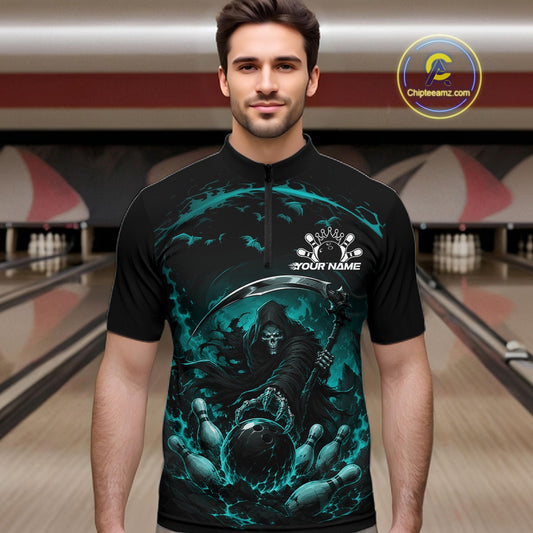 Male model shown from the front wearing a black and cyan blue bowling quarter zip shirt with a grim reaper reaching through swirling flames to command a blazing bowling ball striking scattered pins in a bowling lane.