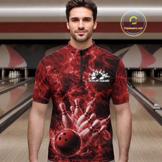 Male model at the bowling lane wearing a quarter-zip with red bowling ball strike artwork and flame accents.