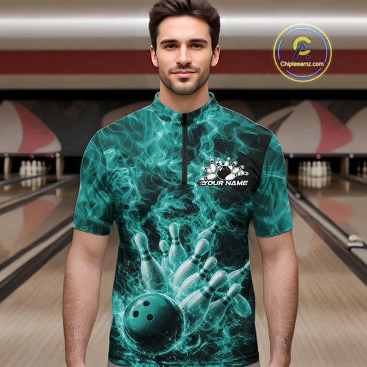 Male model wearing a bowling quarter-zip in a bowling lane with turquoise blue bowling ball artwork and fiery graphics.