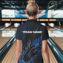 Load image into Gallery viewer, Back view of a female model in a bowling venue wearing a black and blue polo shirt featuring a bowling strike motif with flame effects.