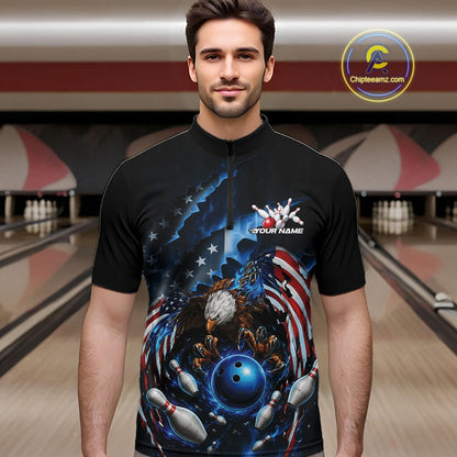 Male model front view at the bowling lane wearing a quarter zip shirt with a bald eagle gripping a blue bowling ball and flying pins.