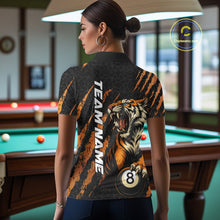 Load image into Gallery viewer, Back view female model wearing a Billiard polo shirt with roaring tiger artwork and orange claw mark accents.