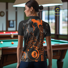 Load image into Gallery viewer, Back view of a female model wearing a polo shirt with billiard 8 ball flame artwork over a blue and green abstract background.