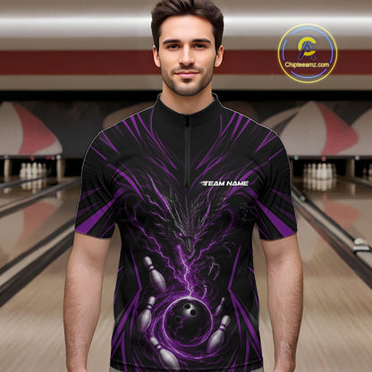 A man wearing a black short-sleeve zip-up bowling jersey with a purple and black dragon  and bowling graphics, standing in a bowling alley.