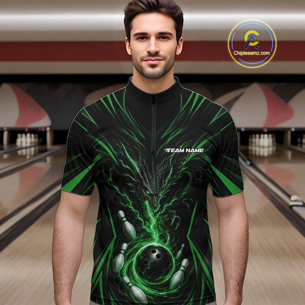 A man wearing a black short-sleeve zip-front jersey with a green and gray bowling-themed graphic print, standing in a bowling alley. The jersey has a white 'TEAM NAME' placeholder on the chest