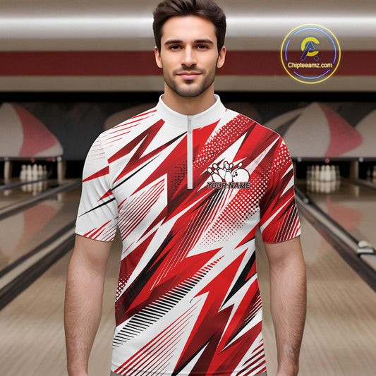 Man wearing a red and white bowling shirt with a pattern in a bowling alley.