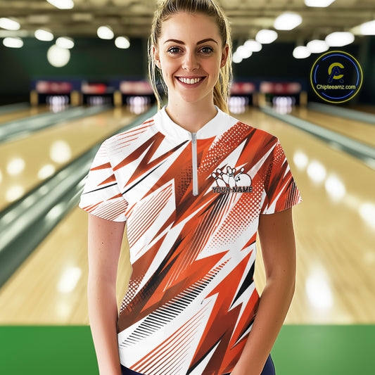 Woman wearing a red and white bowling shirt with a pattern in a bowling alley.