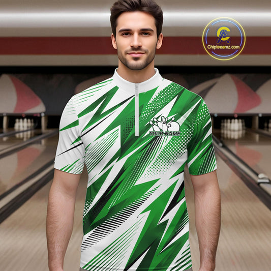 Man wearing a green and white bowling shirt with a pattern in a bowling alley.