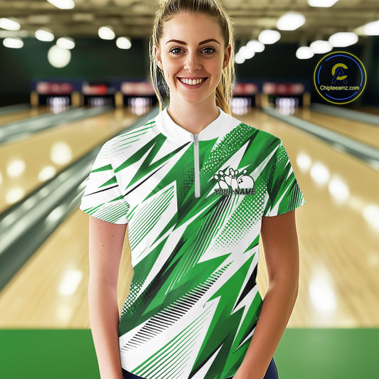 Woman wearing a green and white bowling shirt with a logo on a bowling alley background