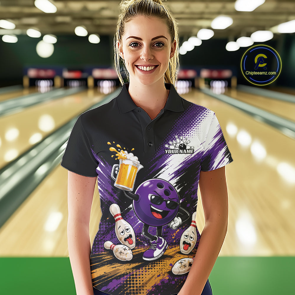 A woman stands in a bowling alley wearing a custom short-sleeve polo shirt with a purple and black bowling-themed graphic featuring bowling balls and pins. The shirt has a black left shoulder, a purple and white graphic body, and a small white 'YOUR NAME' placeholder on the chest.