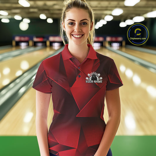 Woman wearing a red and black bowling shirt with a logo in a bowling alley.