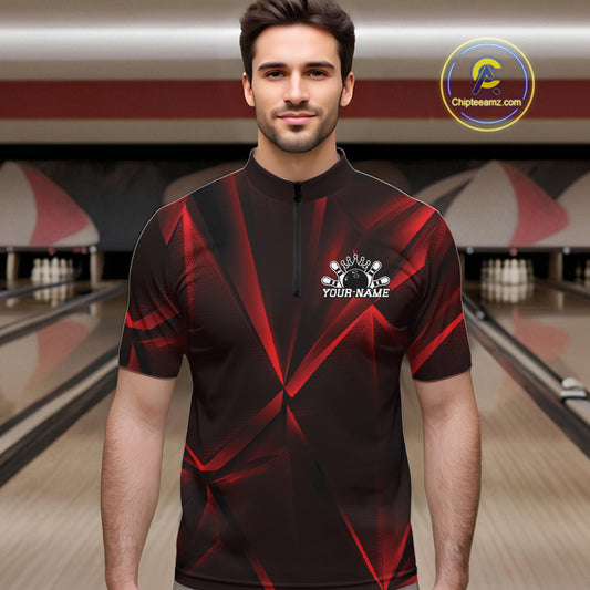 Man wearing a black and red bowling shirt with a logo and text in a bowling alley.