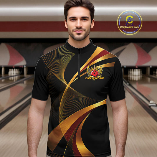 Man wearing a black and gold bowling shirt with a logo in a bowling alley.