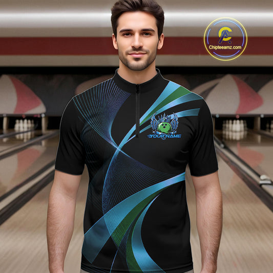 Man wearing a black bowling shirt with blue and green designs in a bowling alley.