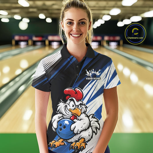 A woman wearing a custom bowling shirt with a cartoon rooster graphic, standing in front of a blurred bowling alley background. The shirt features a black, blue, and white design with a rooster holding a bowling ball.