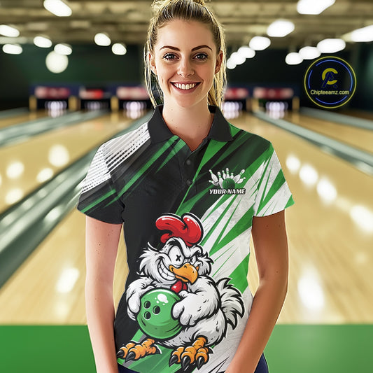 A woman stands in a bowling alley wearing a custom-designed bowling shirt with a cartoon rooster graphic and the text 'YOUR NAME!'. The background shows blurred bowling lanes.