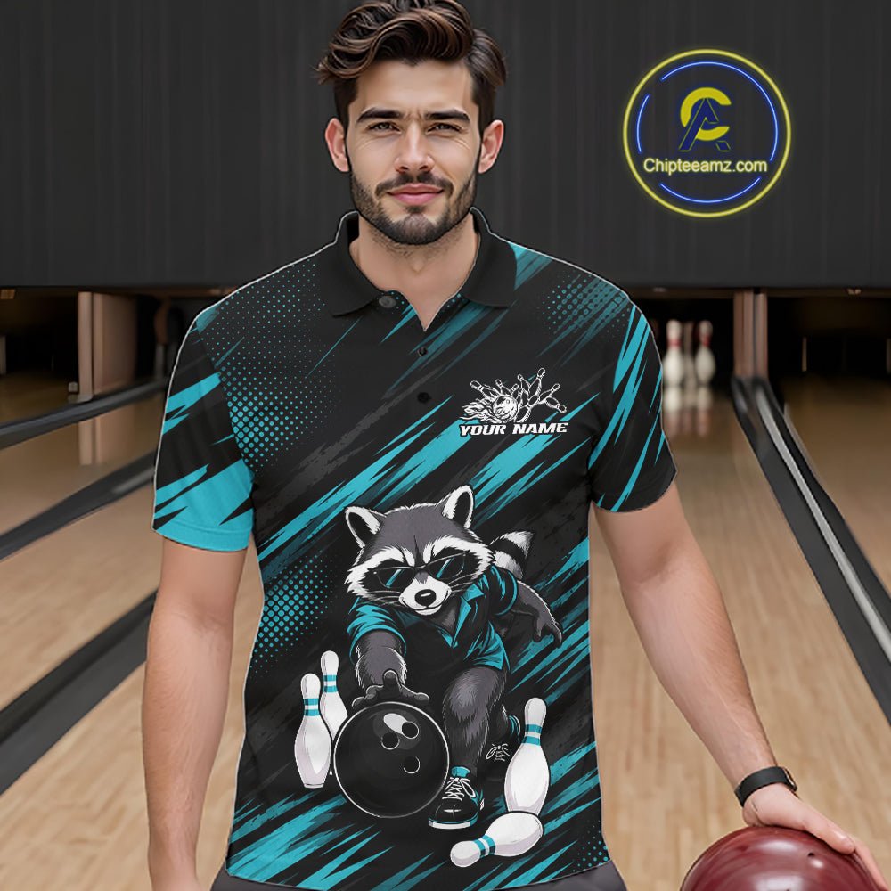 A man wearing a custom bowling polo shirt with a raccoon graphic, standing in a bowling alley. The shirt features a black and teal pattern with a cartoon raccoon holding a bowling ball and pins.