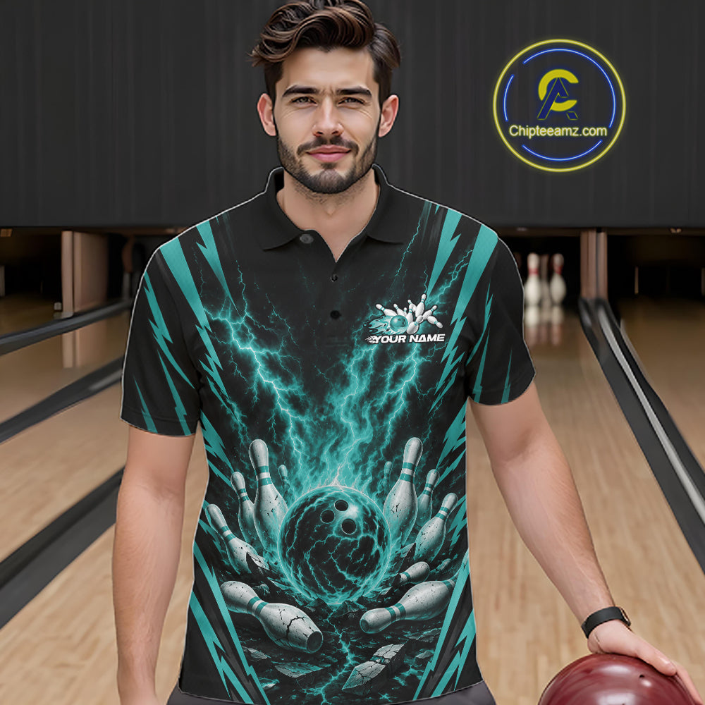 A man wearing a black short-sleeve polo shirt with a teal and gray bowling-themed graphic print, standing in a bowling alley holding a bowling ball. 