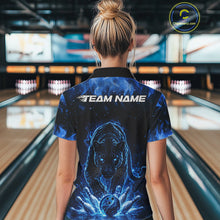 Load image into Gallery viewer, Back view of a female model in a bowling lane wearing a black polo shirt featuring glowing blue electric panther and energetic bowling action graphics.