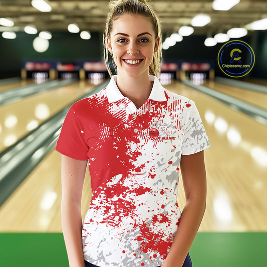 Female model front view in bowling lane wearing white polo shirt with red and white splatter pattern, sporty bowling alley scene