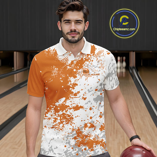 Front view of a male model in a bowling lane wearing an orange and white splatter polo shirt with clean athletic bowling visuals.