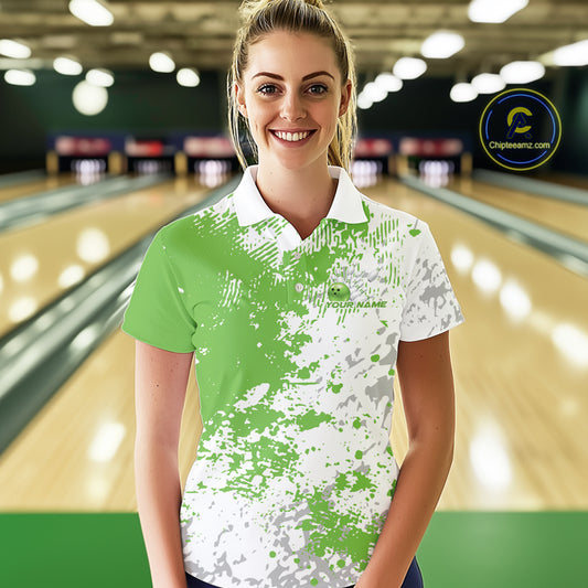 Female model front view in bowling lane wearing white polo shirt with green and white splatter pattern, sporty casual bowling venue scene