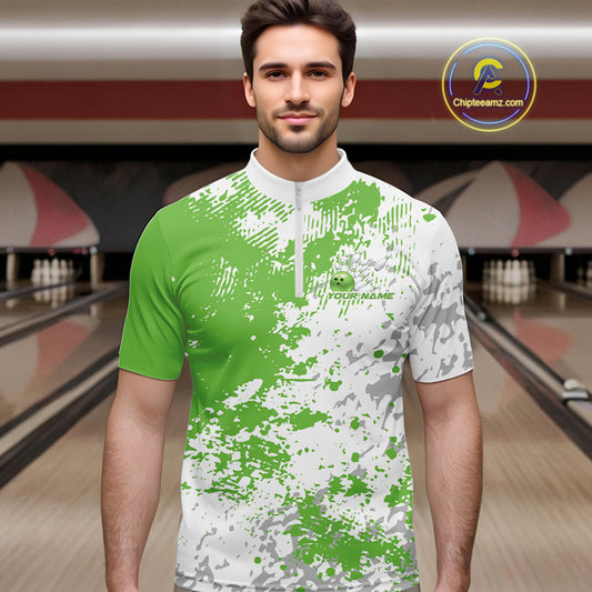 Male model in a bowling lane wearing green and white quarter zip shirt, front view showcasing splatter pattern with clean abstract bowling-inspired styling