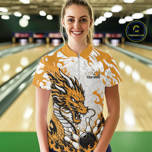 Woman wearing a bowling shirt with a dragon design in a bowling alley.