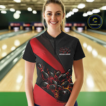 Load image into Gallery viewer, Female model front view in bowling alley wearing black and red quarter zip shirt with flame bowling action artwork