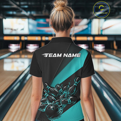 Back view female model in bowling alley wearing black and turquoise blue quarter zip shirt featuring flaming bowling action graphics