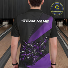 Load image into Gallery viewer, Male model seen from the back in a bowling lane wearing a black and purple polo shirt featuring a flame bowling ball striking pins in a dynamic motion design.
