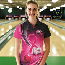 Load image into Gallery viewer, Female model in a black and pink bowling polo with breast cancer awareness ribbons and bowling artwork, front view inside a bowling alley