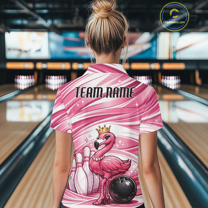 Back view of a female model in a bowling alley wearing a pink quarter-zip shirt showcasing a crowned flamingo beside bowling pins and a bowling ball.