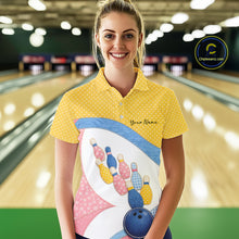 Load image into Gallery viewer, Female model at a bowling lane wearing a bowling polo shirt with vibrant patchwork bowling ball and pin graphics accented by polka dots.