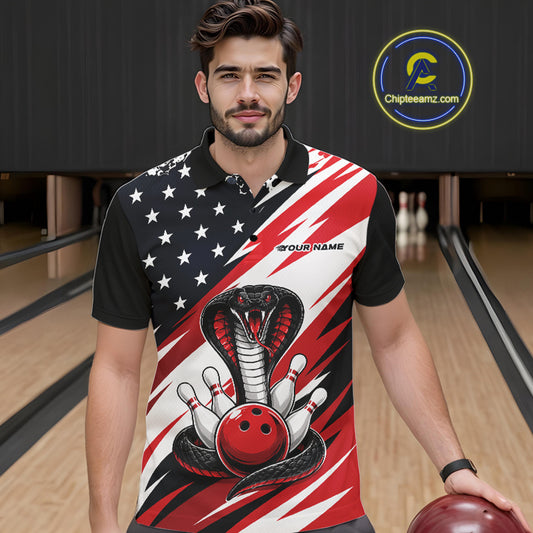 A man stands in a bowling alley wearing a black, white, and red bowling shirt with stars, diagonal stripes, a cobra, pins, and an red ball.