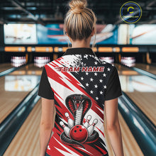 Load image into Gallery viewer, Back view of a woman in a bowling alley wearing a black, white, and red american flag cobra-themed shirt with “Team Name” across the shoulders.