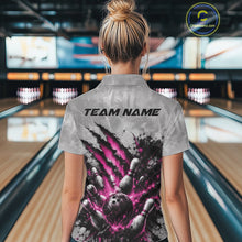Load image into Gallery viewer, Back view of a female model wearing a gray bowling polo shirt showcasing a dramatic pink bowling ball and pins graphic with claw-mark artwork at a bowling lane.